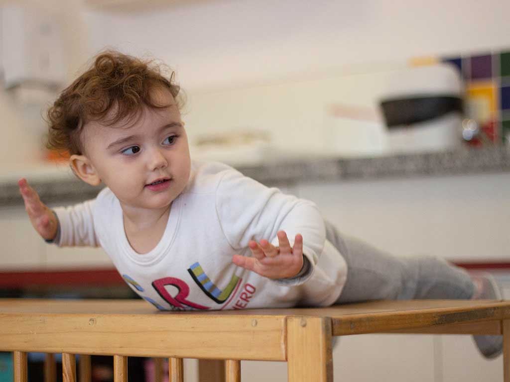 Unidade Uniepre Cantareira - Bebê se equilibrando em mobiliário pikler